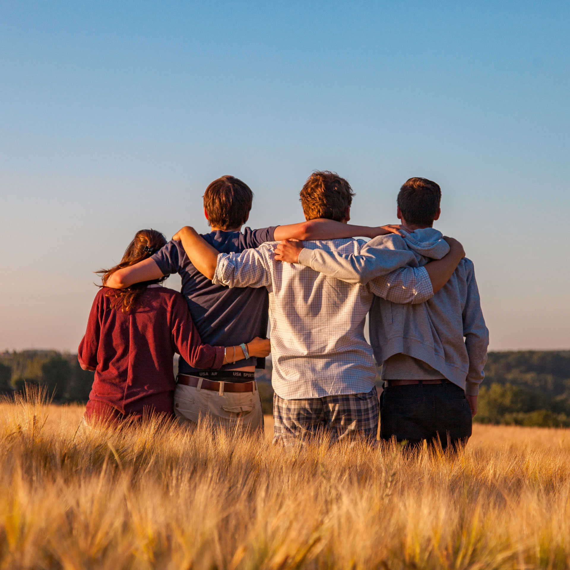 Four friends hugging