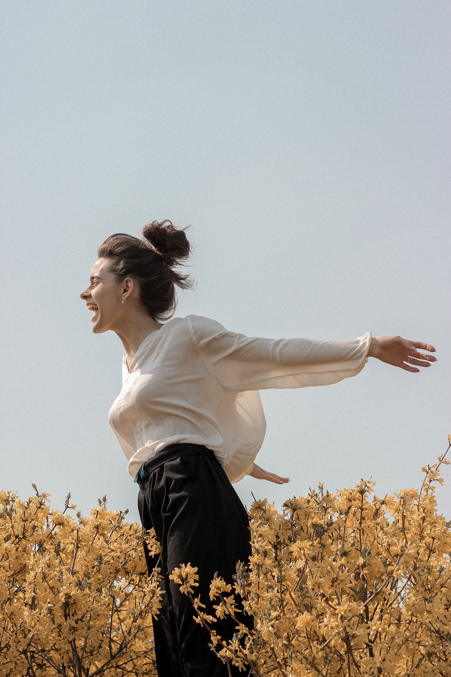 Woman smiling in a field of flowers